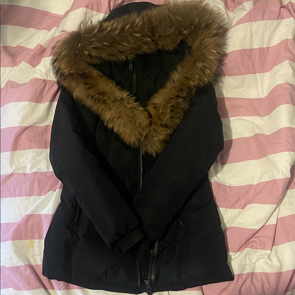 This a  Medium black parka coat with a fur trim hood. Barley worn. Cleaned.